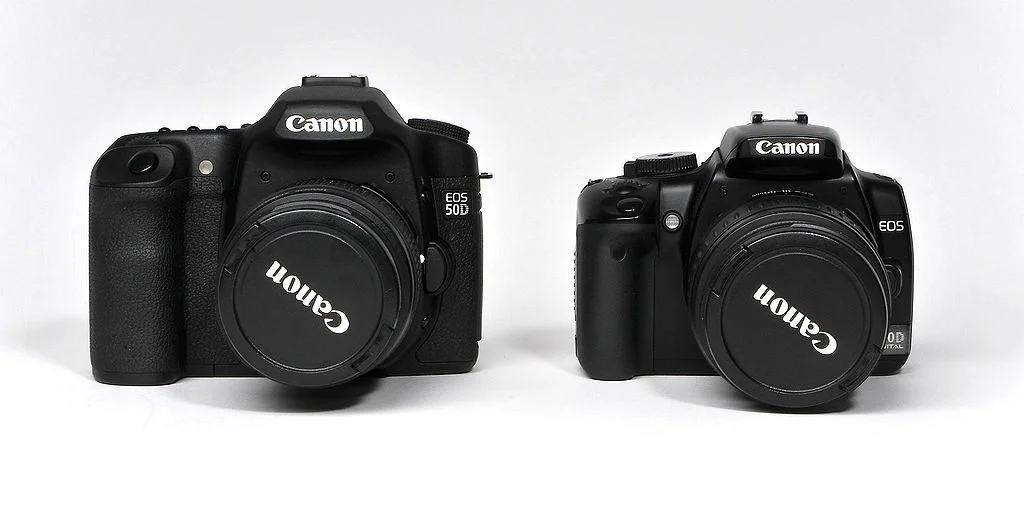 Two black Canon branded cameras.