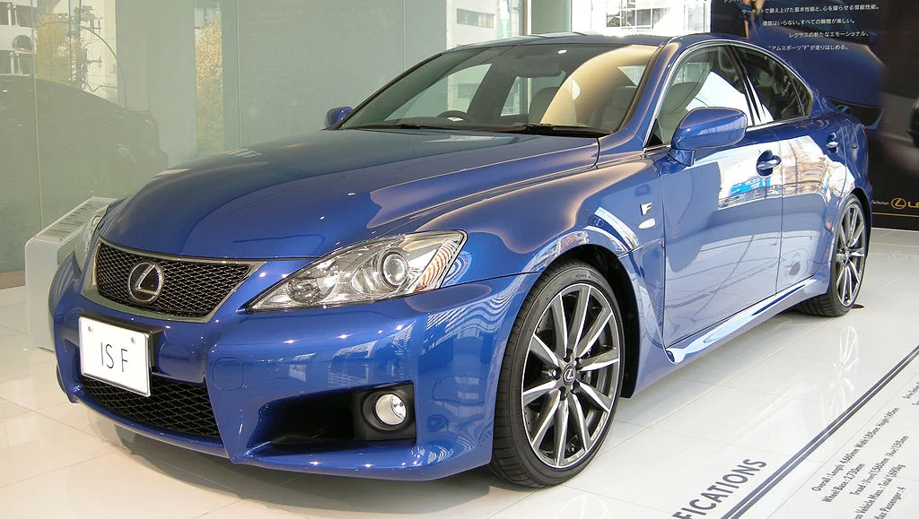 A blue Japanese branded car in a showroom.