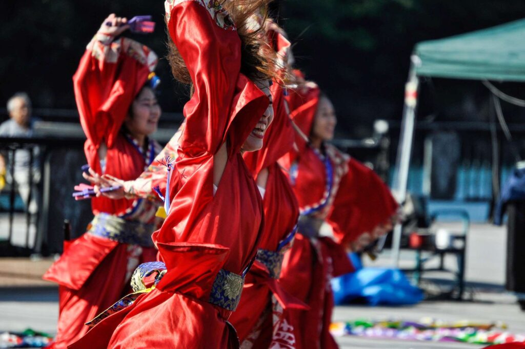 Three women performing a Japanese dance