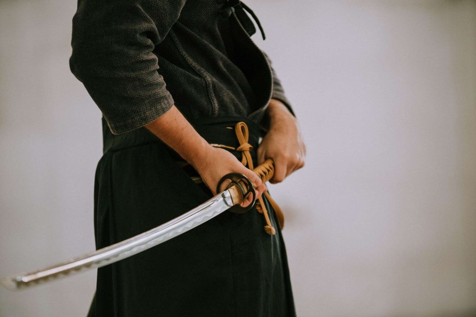 A man in black holding a sword